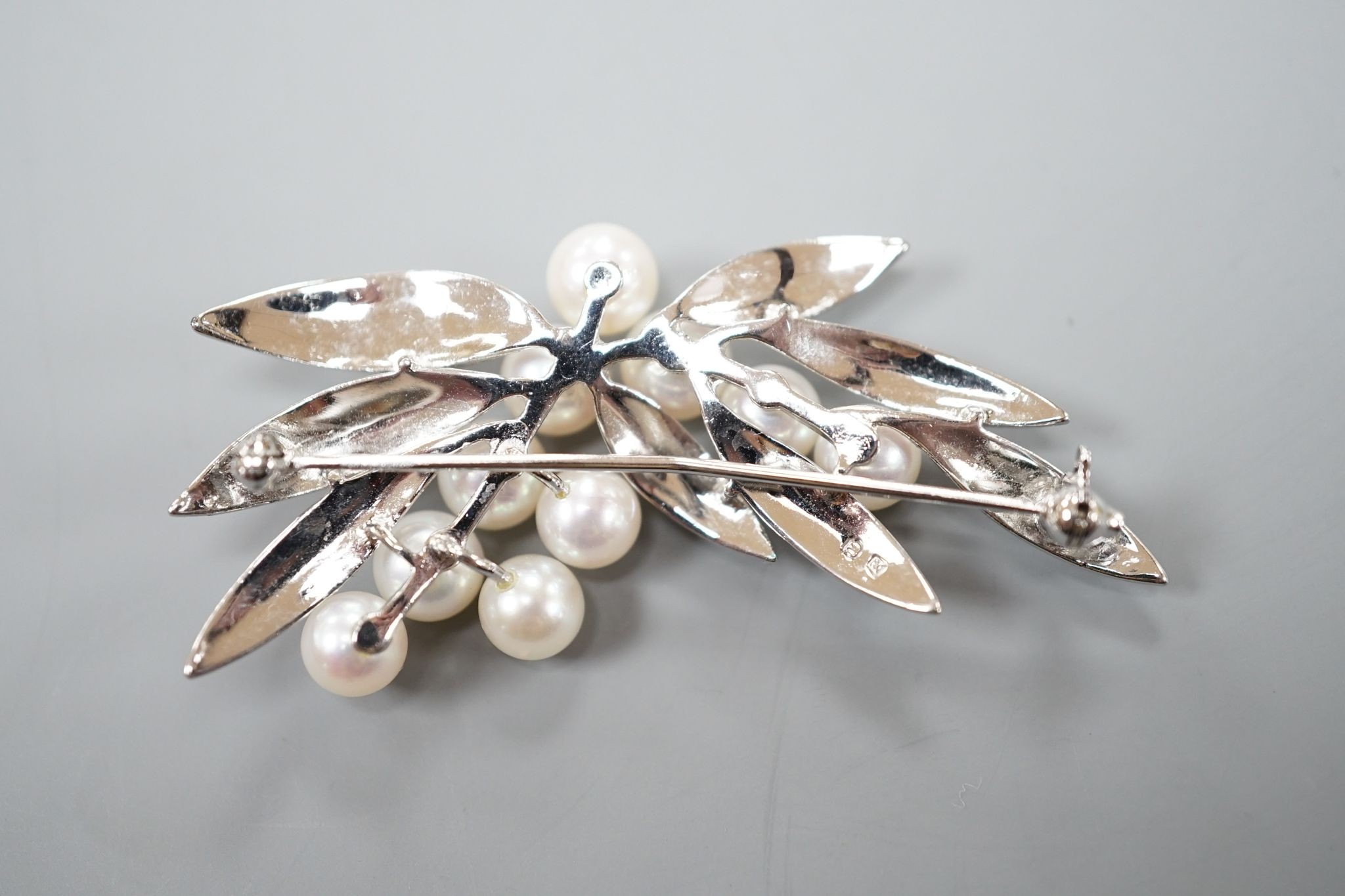 A Mikimoto cultured pearl cluster set metal spray brooch, 54mm.